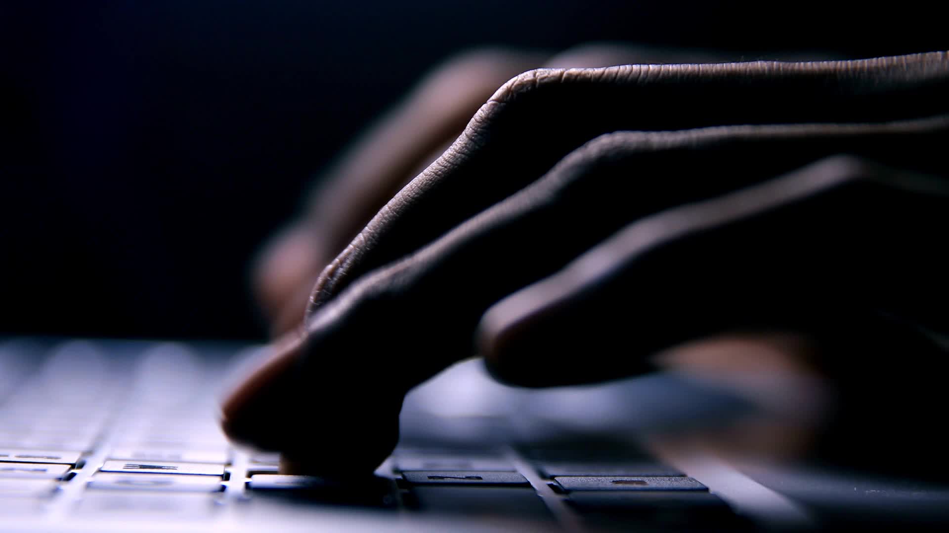 Hands typing on laptop keyboard